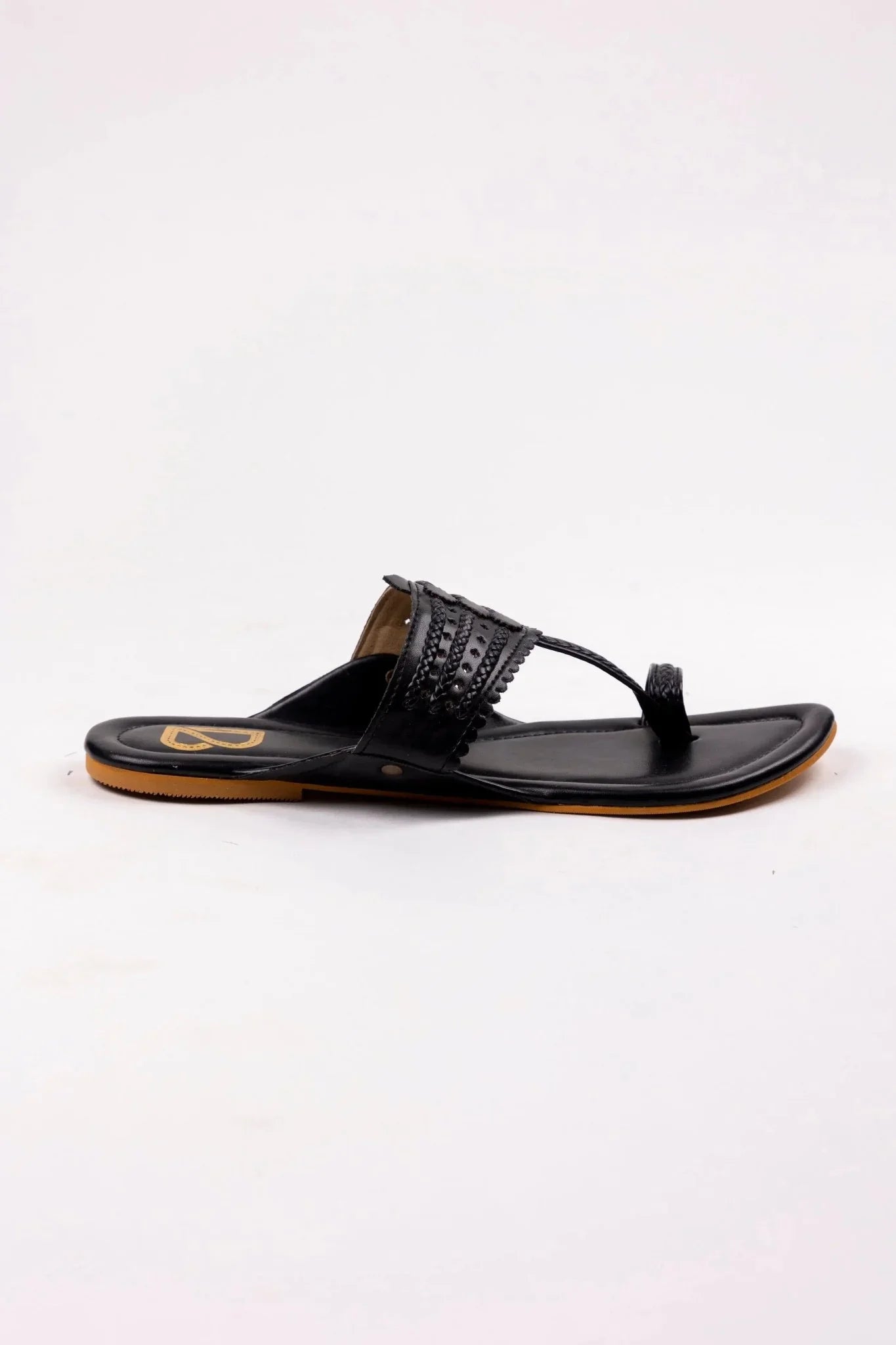 Handcrafted black women’s leather jutti sandal with detailed strap and tan sole from Label Deepti Bajaj