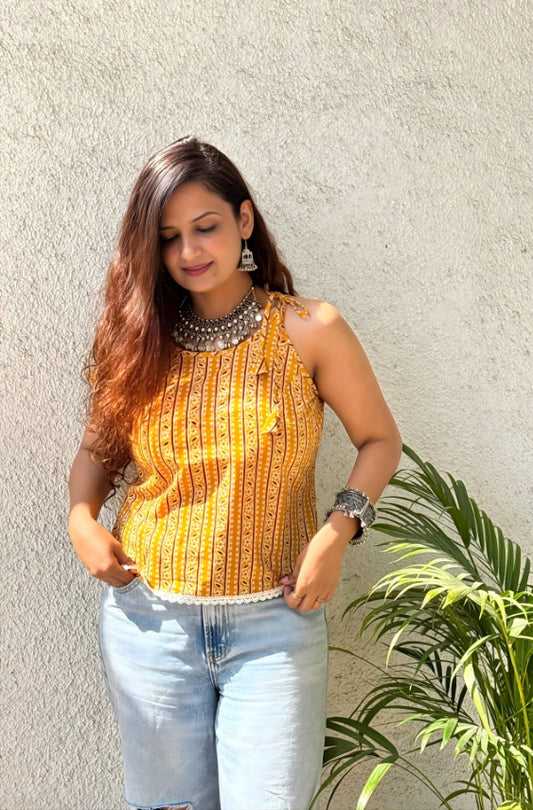 A close-up of the Sunheri product, showcasing its intricate gold filigree design against a dark background.